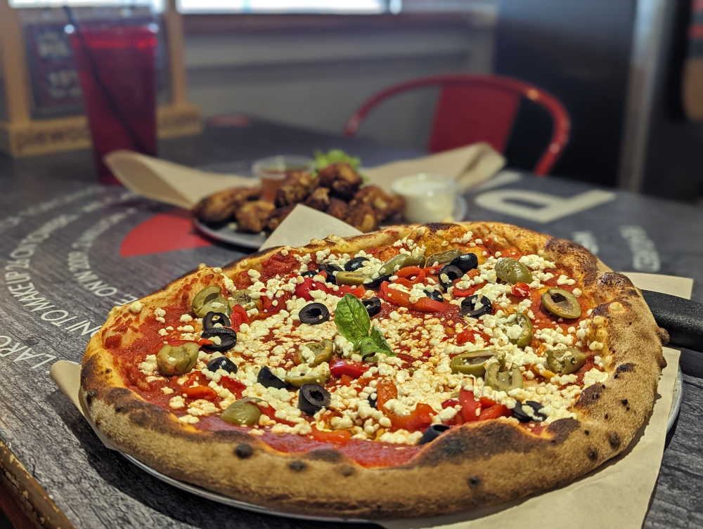 Pizza with olives, red peppers and cheese from PIE Wood Fired Pizza Joint